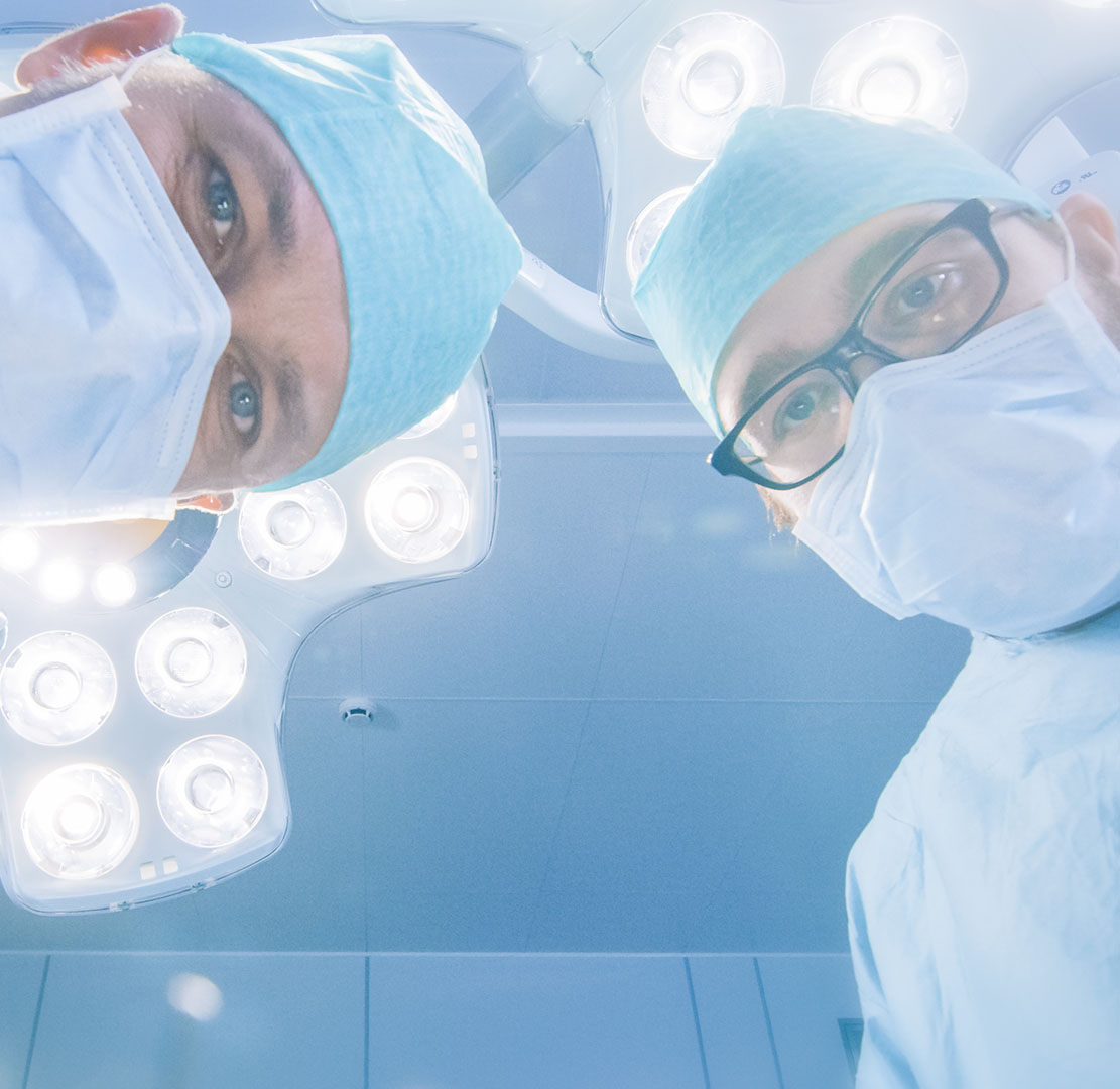 Low Angle Shot POV Patient View: Two Professional Surgeons Holdi