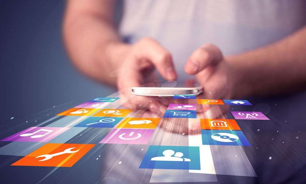 Man holding smart phone with colorful application icons Mobile Apps