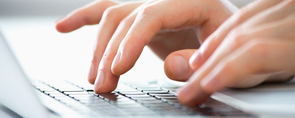 Close-up of hands of business man typing on a laptop. Online Video Marketing